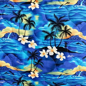 May include: A blue and yellow patterned fabric featuring palm trees, flowers, and the words "Aloha" and "Hawaii".