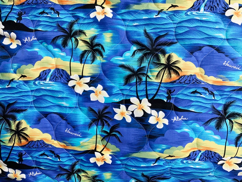 May include: A blue and yellow patterned fabric featuring palm trees, flowers, and the words "Aloha" and "Hawaii".