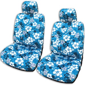 May include: Two blue and white car seat covers with a tropical floral pattern featuring hibiscus flowers and sea turtles. The covers have a black trim and a matching headrest.