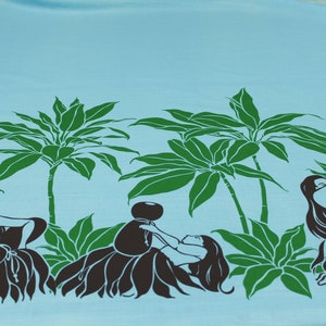May include: A blue fabric with a repeating pattern of palm trees and hula dancers. The dancers are silhouetted in black and are holding a bowl or a flower. The palm trees are green.