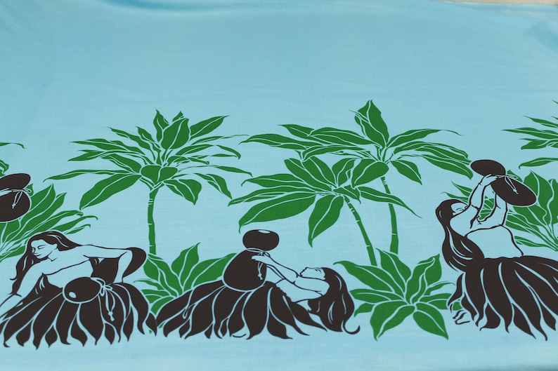 May include: A blue fabric with a repeating pattern of palm trees and hula dancers. The dancers are silhouetted in black and are holding a bowl or a flower. The palm trees are green.