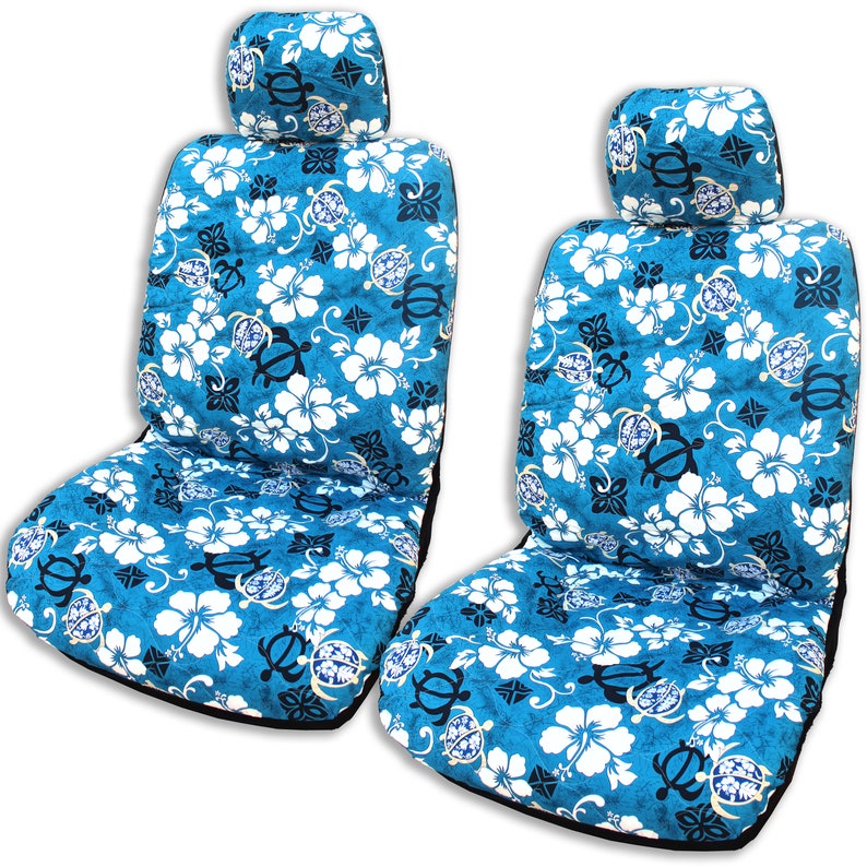 May include: Two blue and white car seat covers with a tropical floral pattern featuring hibiscus flowers and sea turtles. The covers have a black trim and a matching headrest.