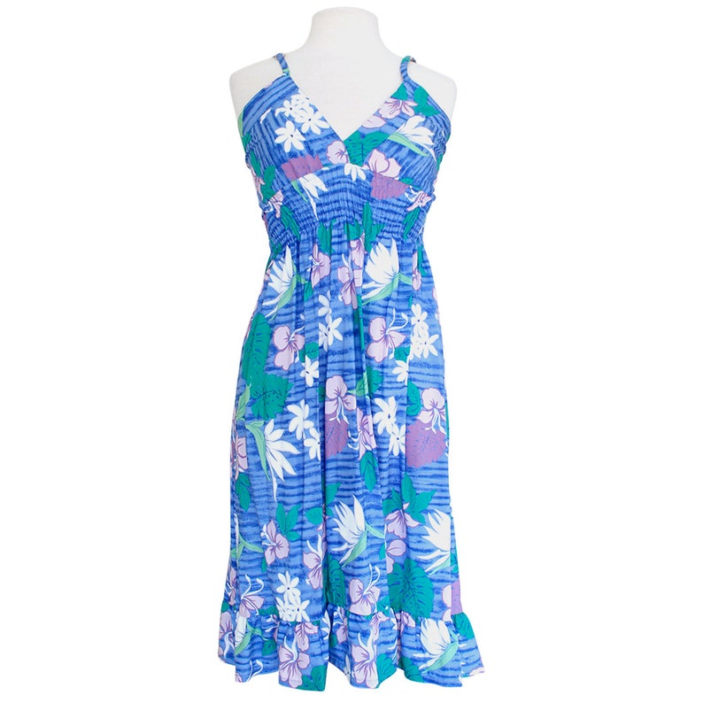May include: A blue floral print midi dress with a V-neckline and thin straps. The dress has a gathered waist and a ruffled hem.