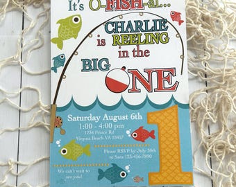 May include: A colorful invitation with a fishing theme. The text reads "It's O-FISH-al... Charlie is REELING in the BIG ONE." Includes details for a first birthday party: date, time, location, and RSVP information. Features fish illustrations and a large number "1".