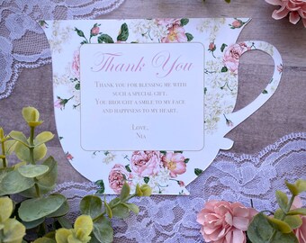 May include: A white teacup with a floral design and a thank you message that reads "Thank You for blessing me with such a special gift. You brought a smile to my face and happiness to my heart. Love, Nia."