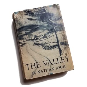 May include: A vintage book cover with a black and white illustration of a snowy landscape with a winding road and a farmhouse. The title of the book is "THE VALLEY" by NATHAN ASCH.