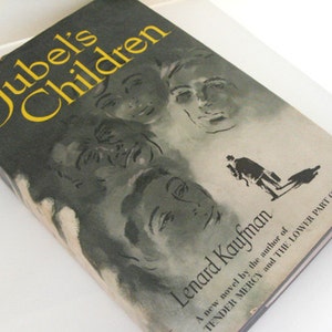 May include: A vintage book titled "Jubel's Children" by Lenard Kaufman. The cover has a dark background with yellow lettering and illustrations of faces. A silhouette of a person is also visible.