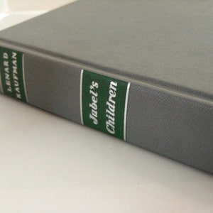 May include: A hardback book with a grey cover. The spine features green and white labels with the title "Jubel's Children" and the author's name, Lenard Kaufman, printed in white.