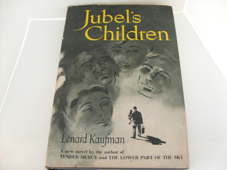 May include: A vintage book cover with the title "Jubel's Children" in yellow lettering against a dark background. The cover features illustrations of faces and a figure walking with a briefcase. The author's name, Lenard Kaufman, is also displayed.