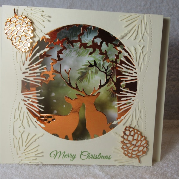 Hand made Christmas shadow box card, diorama greeting cards, die cut original design features deer in the pine trees, reads Merry Christmas