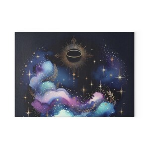May include: A watercolour painting of a dark blue night sky with a golden celestial design. The design features a circle with a black centre and a radiating sunburst pattern. The sky is filled with white stars and a swirling nebula of blue, purple, and pink.