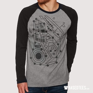 May include: A grey and black long-sleeved shirt with a black and white graphic print of a circuit board design. The shirt has a raglan sleeve style.