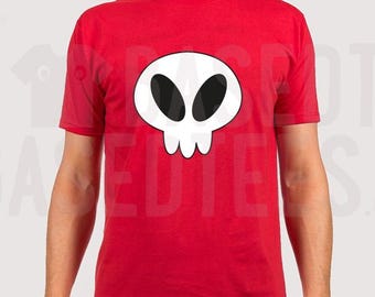 May include: A red t-shirt featuring a white cartoon skull graphic. The skull has two black eyes and a simple smile.