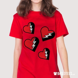 May include: Red t-shirt with four black and white lightning bolt hearts printed on the front.