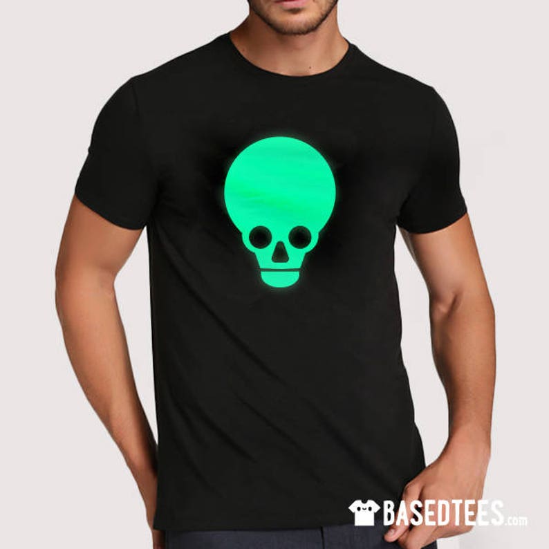May include: A black t-shirt featuring a glow-in-the-dark green skull design.