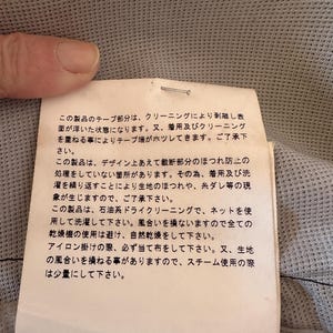 May include: A set of three ceramic mugs with a speckled, matte finish. The mugs are in shades of cream, light gray, and dark gray. Each mug has a simple, minimalist design, perfect for coffee or tea.