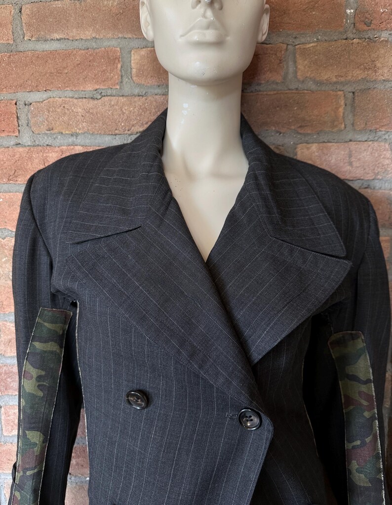 May include: A set of three ceramic mugs with a speckled, matte finish. The mugs are in shades of cream, light gray, and dark gray. Each mug has a simple, modern design and a rounded handle.