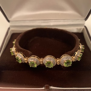 14k gold, diamonds and peridot tennis bracelet by John C. Rinker