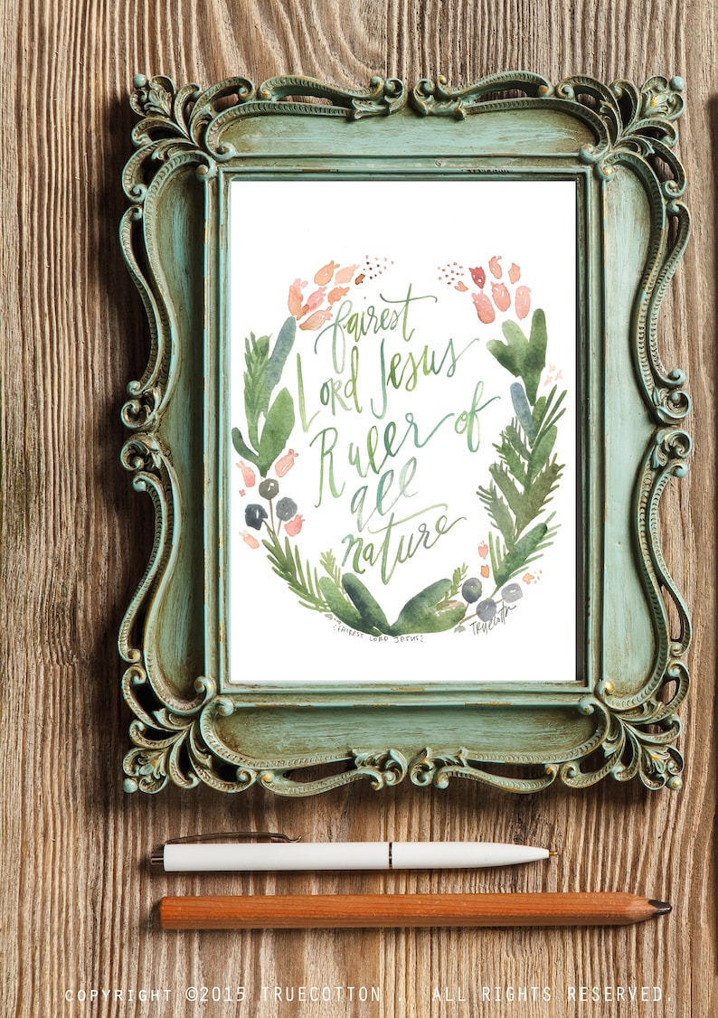 May include: A framed watercolour painting with a green and pink floral wreath surrounding the text "Fairest Lord Jesus, Ruler of all nature".