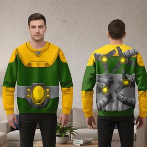 May include: Green and yellow sweatshirt with a superhero design. The front features a yellow chest plate and belt, while the back has a mechanical design. The sleeves and collar are yellow.