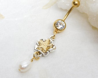 May include: Gold belly button ring with a clear crystal, a gold starfish charm, and a white pearl dangle.
