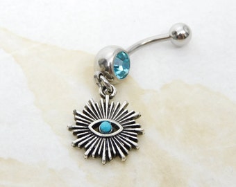 May include: Silver belly button ring with a blue crystal and a charm of a silver eye with a blue center.