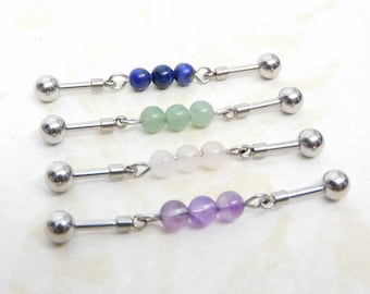 May include: Four pairs of surgical steel barbell earrings with different colored gemstone beads. The beads are blue, green, pink, and purple.
