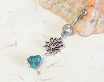 May include: Silver belly button ring with a turquoise stone and a dangling lotus flower charm.