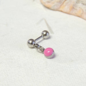 May include: A silver barbell earring with a dangling pink charm. The earring has a straight post with a ball at each end. The charm is a small, round pink bead with a silver border, attached by a small ring.