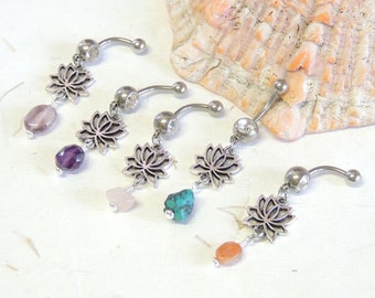 May include: Five silver belly button rings with a dangling lotus flower charm and a gemstone. The gemstones are amethyst, rose quartz, turquoise, carnelian, and amethyst.