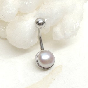May include: A silver belly button ring with a white pearl in a silver setting.