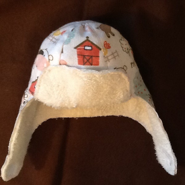 Aviator style hat for baby boy with flaps for ears which can be worn up or down. Fleece lined.