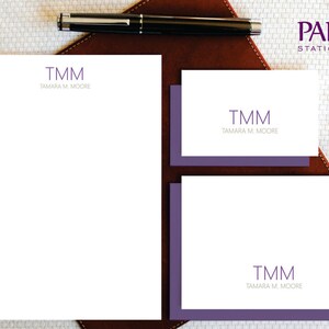May include: A set of stationery featuring a purple monogram with the initials "TMM" and the name "TAMARA M. MOORE" printed on white paper. The stationery includes a notepad and two notecards.