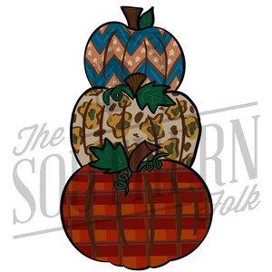 May include: A stack of three pumpkins with different patterned designs. The bottom pumpkin is red and black plaid, the middle pumpkin is beige with a brown and green leopard print, and the top pumpkin is blue with white stars and a peach chevron pattern.