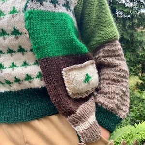 May include: A brown, green, and white knitted cardigan with a patch pocket on the sleeve. The cardigan has a button closure and a striped pattern.