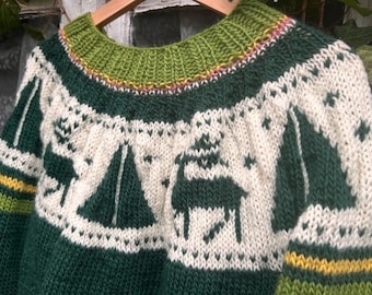 May include: Hand-knitted green and white sweater with a reindeer and sailboat pattern. The sweater features a green collar and cuffs with yellow accents. The design includes sailboats, reindeer, and star patterns.