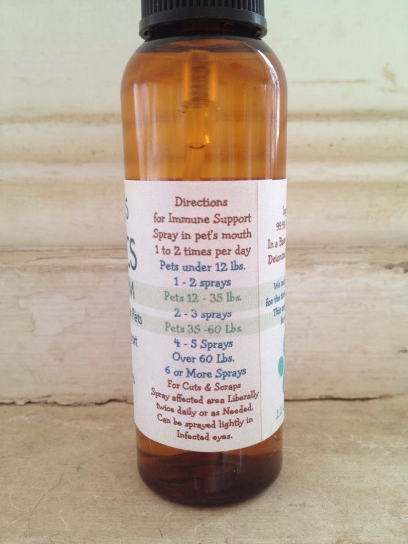 May include: A brown glass bottle with a spray nozzle and a white label. The label has directions for immune support for pets, including dosage recommendations based on weight. The label also includes instructions for using the spray for cuts and scrapes.
