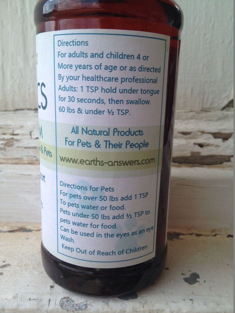 May include: A brown glass bottle with a white label. The label has the text "Directions" and instructions for using the product for adults, children, and pets. The label also includes the website "www.earths-answers.com".