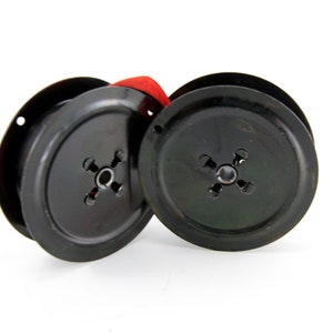 Vintage Smith-Corona and Royal typewriter ribbons on metal spools.