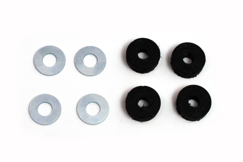 May include: A set of six washers, four black and two silver. The washers are round with a hole in the centre.