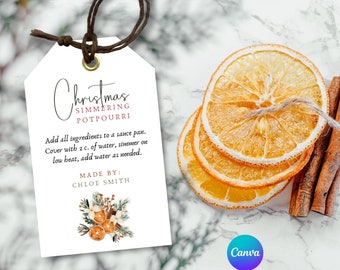 May include: A white gift tag with a handwritten title "Christmas Simmering Potpourri". The tag includes instructions for making potpourri and a handwritten note "Made By: Chloe Smith". The tag is decorated with a watercolor illustration of oranges, cinnamon sticks, and evergreen sprigs.