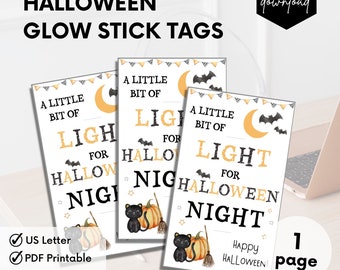 May include: Printable Halloween glow stick tags featuring a black cat, pumpkin, and a crescent moon with bats. The text reads "A little bit of light for Halloween night".