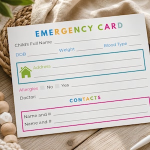 May include: A white rectangular emergency card with colorful text and lines for information. It features fields for child's full name, DOB, weight, blood type, address with a green house icon, allergies, doctor, and contact names and phone numbers.