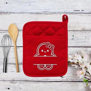May include: Red quilted oven mitt with a white outline of a smiling octopus with a bow. The octopus has a blank space for a name.