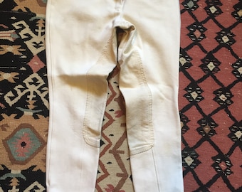 May include: A pair of white riding breeches with knee patches.