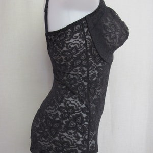 May include: Black lace bodysuit with a fitted silhouette and adjustable straps.