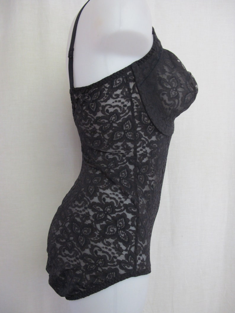 May include: Black lace bodysuit with a fitted silhouette and adjustable straps.