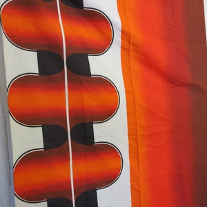 May include: A white fabric with a repeating pattern of orange, red, and black curved shapes. The fabric has a gradient effect, with the orange fading to red.