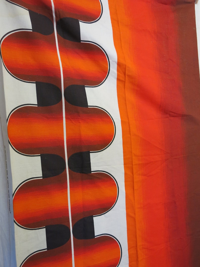May include: A white fabric with a repeating pattern of orange, red, and black curved shapes. The fabric has a gradient effect, with the orange fading to red.