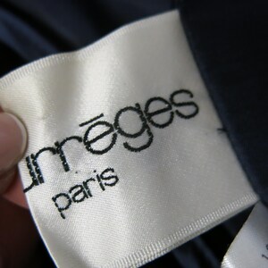 May include: White label with black text that reads "m&egrave;ges Paris".